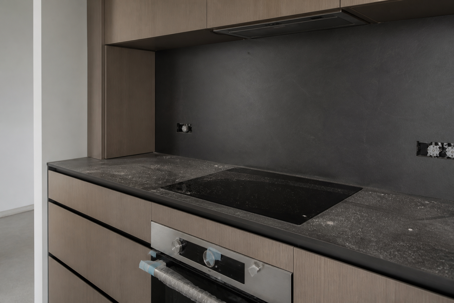 Fine plaster dust on a new kitchen cooktop after the trades leave