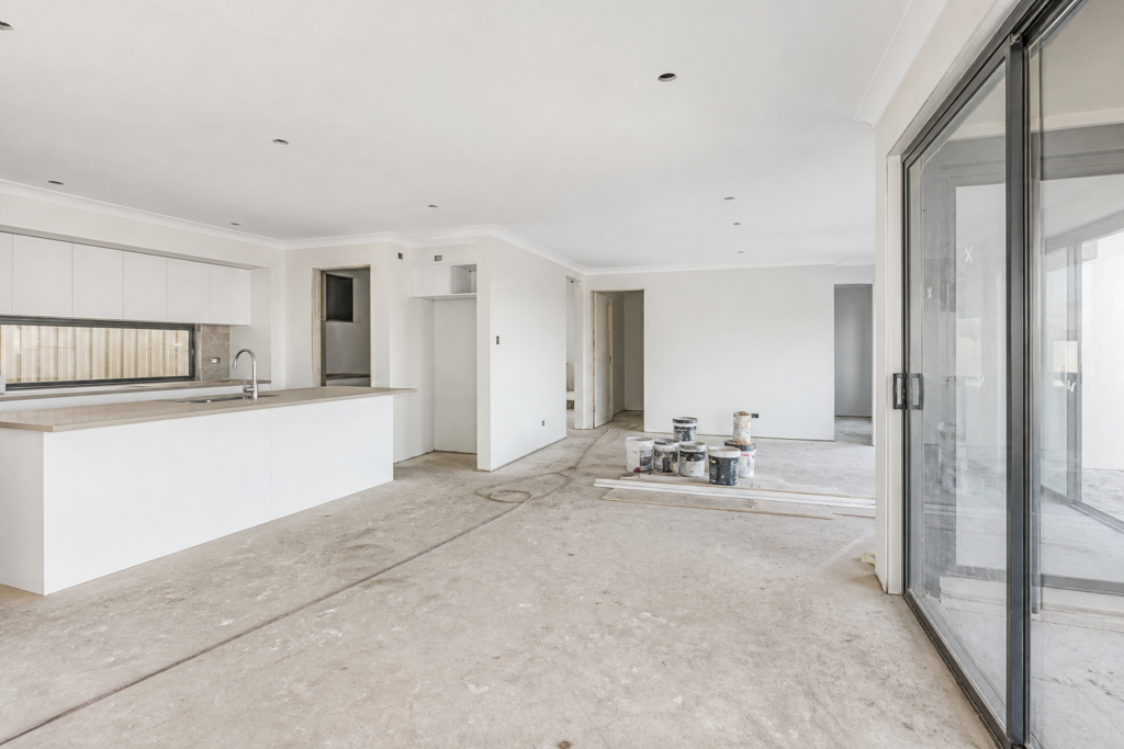 Empty new-build interior with construction dust before a builders clean